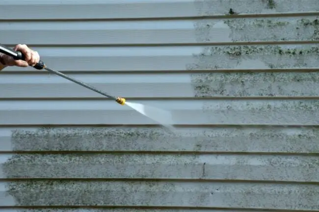 Power washing a house